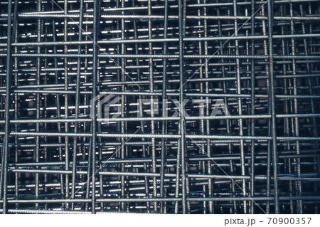 Steel bar for building materials. Wire reinforcing mesh. Industrial grunge background Steel bar for building materials. Wire reinforcing mesh. Industrial grunge background 70900357