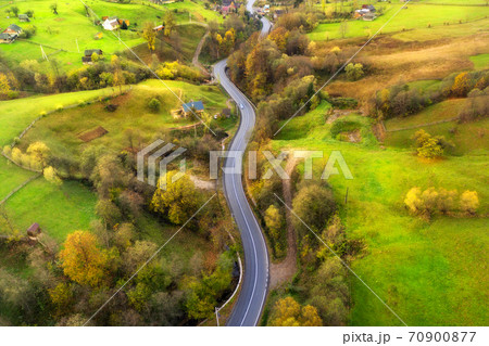 Aerial view of beautiful winding road in green hills 70900877