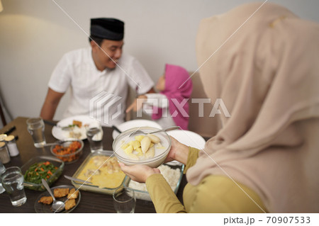 muslim mother serving some food for family muslim mother serving some food for family 70907533
