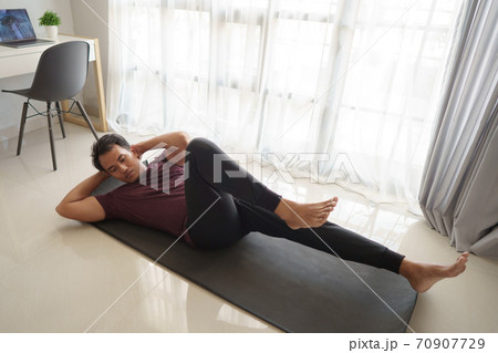asian man sitting up workout from home 70907729