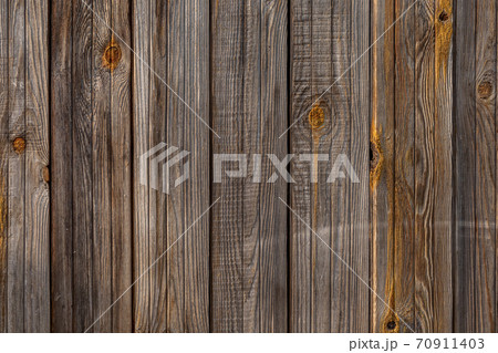 the texture of an old wooden Board. The wall of an old house, sheathed in boards. 70911403