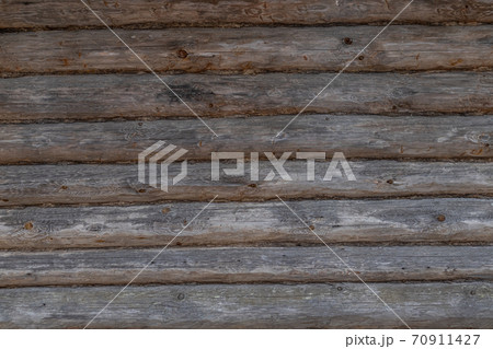 the texture of an old wooden Board. The wall of an old house, sheathed in boards. 70911427