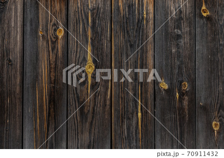 the texture of an old wooden Board. The wall of an old house, sheathed in boards. the texture of an old wooden Board. The wall of an old house, sheathed in boards. 70911432