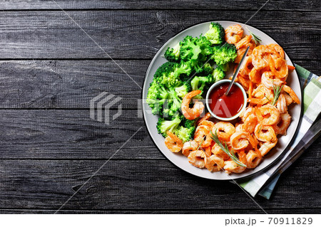 Garlic butter prawns with broccoli, top view 70911829