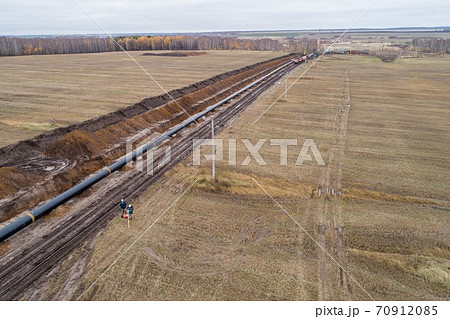 aerial photograph of the laying pipe of large diameter in clay soil. Autumn aerial photograph of the laying pipe of large diameter in clay soil. Autumn 70912085