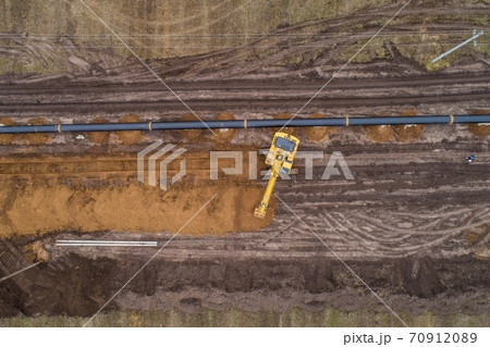 aerial photograph of the laying pipe of large diameter in clay soil. Autumn aerial photograph of the laying pipe of large diameter in clay soil. Autumn 70912089