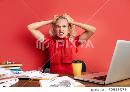 young stressed female working with computer laptop in frustration, depression young stressed female working with computer laptop in frustration, depression 70913373