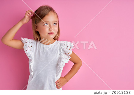 thoughtful little girl looking away, dreaming thoughtful little girl looking away, dreaming 70915158