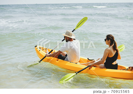 Couple kayaking on lake 70915565
