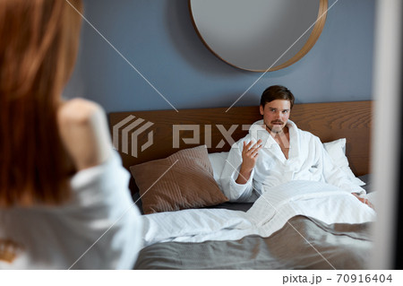come here. man calls his woman to bed 70916404