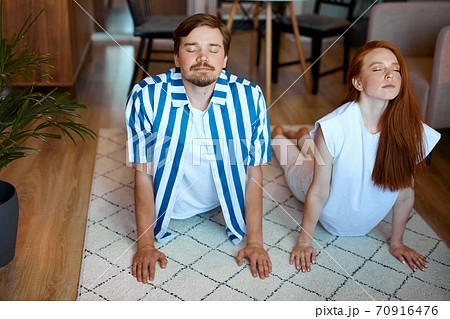 portrait of couple stretching before yoga 70916476