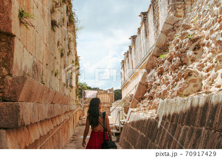 Woman at ruins of the ancient city of Uxmal in Merida, Mexico Woman at ruins of the ancient city of Uxmal in Merida, Mexico 70917429
