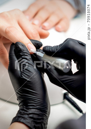 Manicure master applying transparent varnish Manicure master applying transparent varnish 70918074