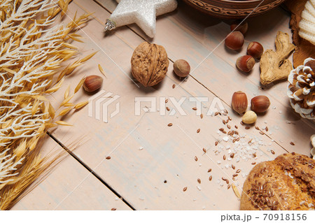 christmas decoration in rustic style and holiday background, still life on wooden backdrop, bread, nuts and other christmas decoration in rustic style and holiday background, still life on wooden backdrop, bread, nuts and other 70918156