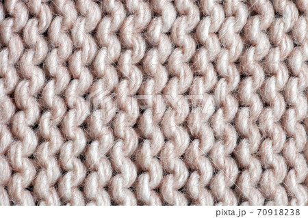 Texture beige acrylic knitted sweater. Garter stitch knitting pattern close up 70918238
