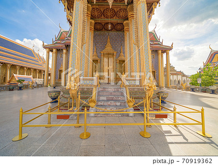 Golden pagoda at Temple of the Emerald Buddha in Bangkok, Thailand. Wat Phra Kaew and Grand palace in old town, urban city. Buddhist temple, Thai architecture. A tourist attraction Golden pagoda at Temple of the Emerald Buddha in Bangkok, Thailand. Wat Phra Kaew and Grand palace in old town, urban city. Buddhist temple, Thai architecture. A tourist attraction 70919362