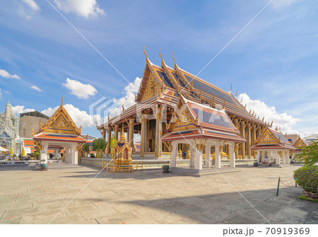 Golden pagoda at Temple of the Emerald Buddha in Bangkok, Thailand. Wat Phra Kaew and Grand palace in old town, urban city. Buddhist temple, Thai architecture. A tourist attraction Golden pagoda at Temple of the Emerald Buddha in Bangkok, Thailand. Wat Phra Kaew and Grand palace in old town, urban city. Buddhist temple, Thai architecture. A tourist attraction 70919369