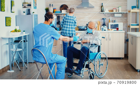 Geriatrician giving elderly patient pills Geriatrician giving elderly patient pills 70919800