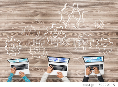Top view of businesspeople sitting at table and using gadgets 70920115