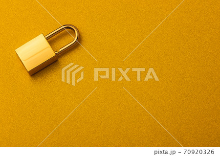 Golden lock on a golden background with empty space for text 70920326
