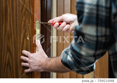 Carpenter at work repairs the door lock. Carpentry. Carpenter at work repairs the door lock. Carpentry. 70921098
