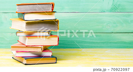 Books on wooden desk table and abstract background. Education background. Copy Space. Back to school. Books on wooden desk table and abstract background. Education background. Copy Space. Back to school. 70922097