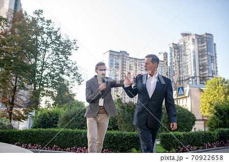 Mature man reluctant to give interview walking away from male journalist 70922658