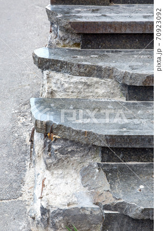 Marble steps in broken condition, close-up of damages requiring repairs and restoration of the stairs. Marble steps in broken condition, close-up of damages requiring repairs and restoration of the stairs. 70923092