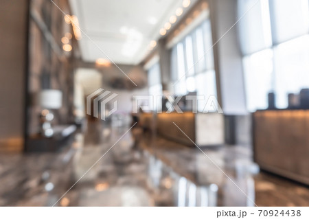 Hotel or office building lobby blur background interior view toward reception hall, modern luxury white room space with blurry corridor and building glass wall window Hotel or office building lobby blur background interior view toward reception hall, modern luxury white room space with blurry corridor and building glass wall window 70924438