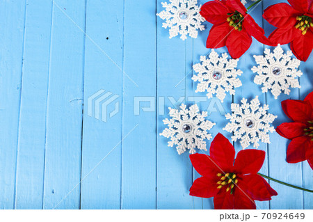 Christmas still life. Snowflakes and poinsettia Christmas still life. Snowflakes and poinsettia 70924649