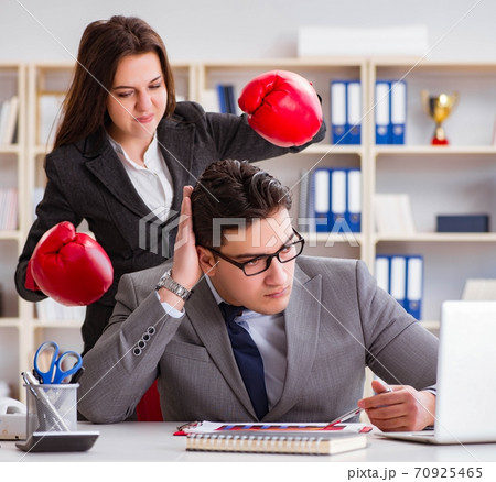 Office conflict between man and woman 70925465