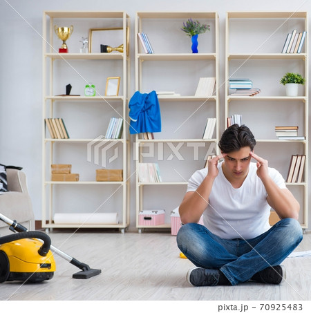 Man doing cleaning at home 70925483