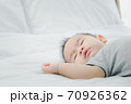 Cute 7 months asian baby girl is sleeping on bed in the morning.Newborn little child sleep have nice dream. 70926362