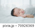 Asian little newborn baby girl sleeping on bed.Happy cute infant sleep on white blanket.family and kid concept. 70926369