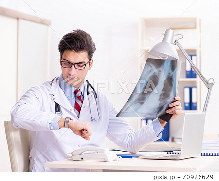 Young handsome doctor working in hospital room 70926629