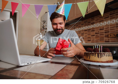 Man celebrating birthday online in quarantine time. 70926768