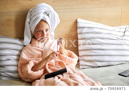 adorable caucasian kid girl watch tv after bathroom 70926971