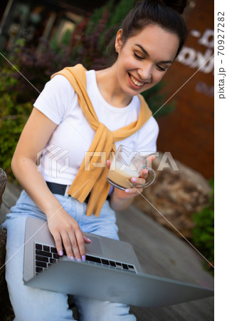 successful woman freelancer cute smiling sitting outdoors with computer 70927282