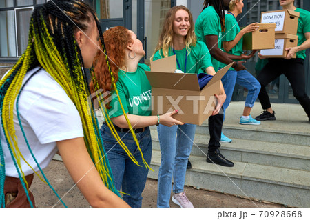interracial group of volunteers working on humanitarian aid project, outdoors interracial group of volunteers working on humanitarian aid project, outdoors 70928668