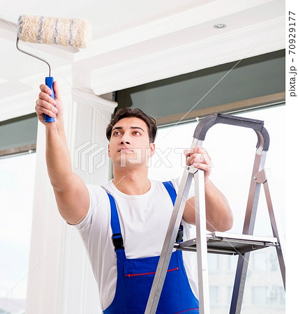Painter repairman working at construction site 70929177