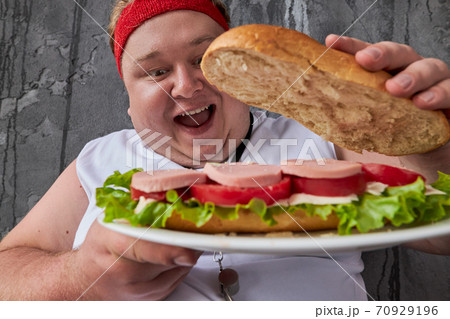 comic overweight man opens inside of sandwich 70929196