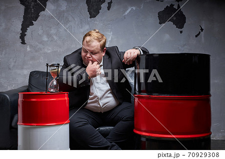businessman thinks how to solve his oil business 70929308