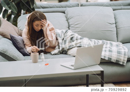 Sick woman with headache sitting at home Sick woman with headache sitting at home 70929892