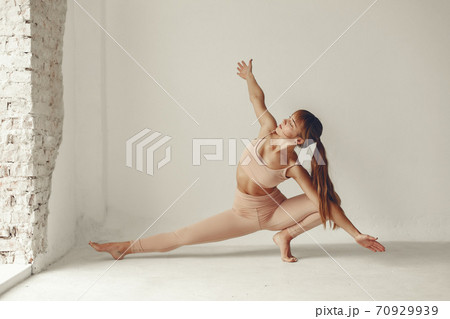 A beautiful girl is engaged in a yoga studio 70929939