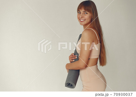 A beautiful girl is engaged in a yoga studio A beautiful girl is engaged in a yoga studio 70930037