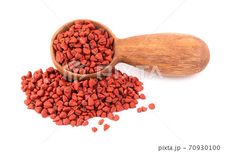 Annatto seeds in wooden spoon, isolated on white background. Achiote seeds, bixa orellana. Natural dye for cooking and food. Close-up. Annatto seeds in wooden spoon, isolated on white background. Achiote seeds, bixa orellana. Natural dye for cooking and food. Close-up. 70930100