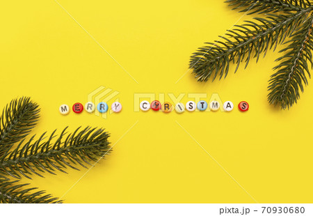 Christmas composition minimalism, letters merry christmas on yellow background. 70930680