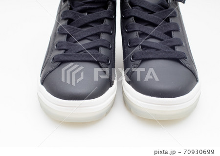Pair of new black sneakers with white sole on white background Pair of new black sneakers with white sole on white background 70930699