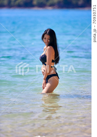 Beautiful asian woman enjoying on a tropical beach Beautiful asian woman enjoying on a tropical beach 70930751