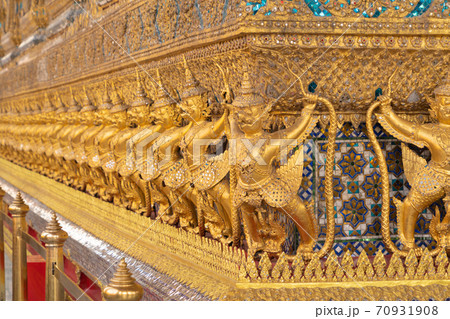 Garuda statue at Golden pagoda at Temple of the Emerald Buddha in Bangkok, Thailand. Wat Phra Kaew and Grand palace in old town, urban city. Buddhist temple, Thai architecture. Garuda statue at Golden pagoda at Temple of the Emerald Buddha in Bangkok, Thailand. Wat Phra Kaew and Grand palace in old town, urban city. Buddhist temple, Thai architecture. 70931908